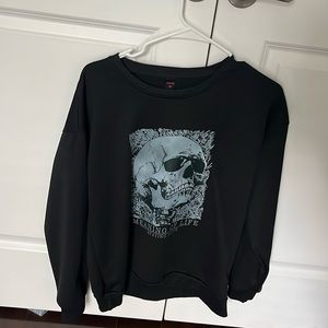 black sweatshirt with blue skull printed on it. size M, from ROMWE. never worn